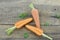 Triangle made of fresh carrots on wooden rustic