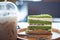 Triangle pandan layer cake filled with cream and red beans