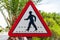 Triangle road sign with schematic walking man