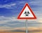 Triangle on rod road sign radiation danger with cloudy sky