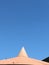 Triangle shape peak on top of tin roof of vintage water tower