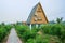 Triangle wooden cabin in orchard