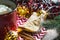 Triangular cookies with powdered sugar and cinnamon on a napkin with a zigzag pattern in the Christmas decor. Red coffee mug with