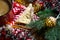 Triangular cookies with powdered sugar and cinnamon on a napkin with a zigzag pattern in the Christmas decor. Red coffee mug with