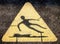 Triangular Hazard Symbol of Man Slipping on Water and Falling