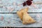 Triangular pies on a table and a spoon with cranberries, top view