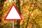 Triangular prohibition sign in the autumn forest