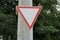 triangular road sign on a pillar give way