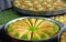 Triangular shaped baklava with pistachio in round tray. turkey specific dessert