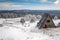 Triangular shaped cabin on a snowy mountain during winter