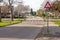 Triangular traffic sign for roundabout, pedestrian crossing, metal post with a triangular plate