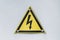 Triangular yellow sign of dangerous electrical voltage