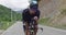 Triathlete Cycling Exercising Road Bike.Sport Concept.Cyclist In Helmet And Sportswear Drinks Water.Triathlon Athlete