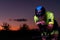 A triathlete rides his bike in the darkness of night, pushing himself to prepare for a marathon. The contrast