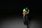 A triathlete rides his bike in the darkness of night, pushing himself to prepare for a marathon. The contrast