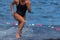 Triathlete swimmer running out of ocean finishing swim race
