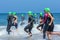 Triathlon athletes running into the sea for swimleg