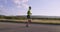 Triathlon - Male triathlete running in triathlon suit training for ironman race. Man runner exercising jogging on the