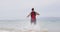 Triathlon swimming - male triathlete swimmer running into ocean for swim