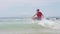 Triathlon swimming man - male triathlete swimmer running into ocean for swim
