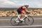 Triathon biking cyclist man triathlete riding racing bike during ironman competition. Road cycling athlete in tri suit