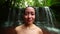 Tribal girl in forest posing on waterfall