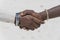 Tribal masai men making handshake in the tropical beach on island Zanzibar, Tanzania, Africa, close up