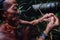 Tribal member Toikot collecting grubs from a fallen sago tree in the mi