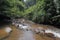 A tributary river in Sri Lanka, water flows between the rocks on the riverbed