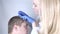 A trichologist doctor drips the serum onto the patient`s hair. Treatment of alopecia. Hair loss, alopecia, pruritus, burning head