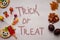 Trick or treat concept lettering. Healthy and unhealthy food in comparison: Alternative to sweets and candies - nuts
