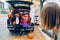 Trick or trunk. Children boy and girl with red pumpkins celebrating October Halloween holiday in trunk of car outdoors. Mother