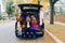 Trick or trunk. Children celebrating Halloween in trunk of car. Boy and girl with red pumpkins celebrating traditional October