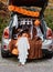 Trick or trunk. Trunk or treat. Little child in Halloween witch hat stands at decorated trunk of car