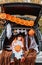 Trick or trunk. Trunk or treat. Little child in witch hat with funny face eating Halloween candies in decorated trunk of car.