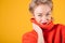 Tricky seductive flirting look woman in red jumper on yellow background