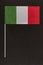 Tricolor Italian flag green white red on black background. Table flag of Italy