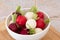 Tricolor radishes in a bowl on a table