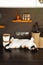 Tricolor shorthaired kitten lying on kitchen table