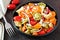 Tricolored tortellini pasta salad on dark wood table