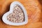 Tricolour quinoa grain super food in heart shaped bowl, top view.