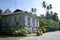 Tricycle Passing Traditional Filipno House on Camuigan Island, M