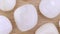 Tridacna rare jewel stones on light varnished wood texture. Moving right seamless loop backdrop