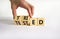 Tried and tested symbol. Businessman turns wooden cubes and changes the concept word `tried` to `tested` on a beautiful white