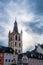 Trier, Rijnland-Palts, Germany, 23th of March, 2024, Trier Town Hall Tower Aglow with Sunlight Against a Moody Sky