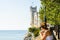 Triest, Italy - 05.08.2015 View on Miramare castle on the gulf of Trieste, Woman in white dress looking at see. Tourist spot,
