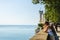 Triest, Italy - 05.08.2015 View on Miramare castle on the gulf of Trieste, Woman in white dress looking at see. Tourist spot,