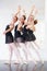 Trifecta of grace. three young ballerinas rehearsing in a studio.