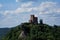 Trifels castle on mountain top with clouds and blue sky