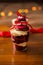 Trifle cake on a wooden table with beautiful bokeh lights